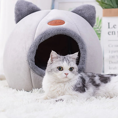 Cozy winter cat bed with a fluffy gray cat lounging nearby.